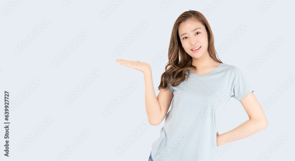 Happy beautiful young asian woman blue background holding copy space imaginary on beauty palm for insert advertisement looking at camera happiness and smiley face Attractive beautiful girl portrait Happy beautiful young asian woman blue background holding copy space imaginary on beauty palm for insert advertisement looking at camera happiness and smiley face Attractive beautiful girl portrait