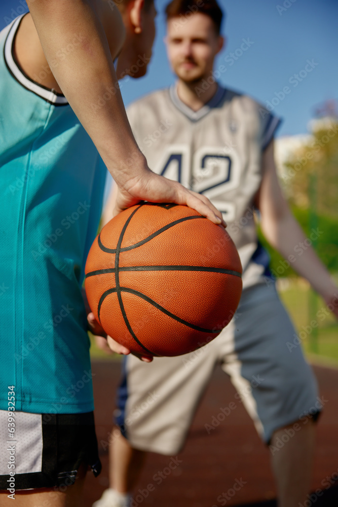 Closeup shot of two men playing basketball