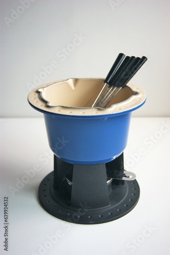 Bright blue fondue set in cast iron.