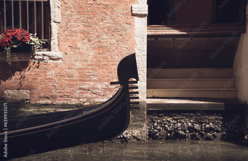 Close up with a traditional gondola boat ride on the water canal in Venice, Italy