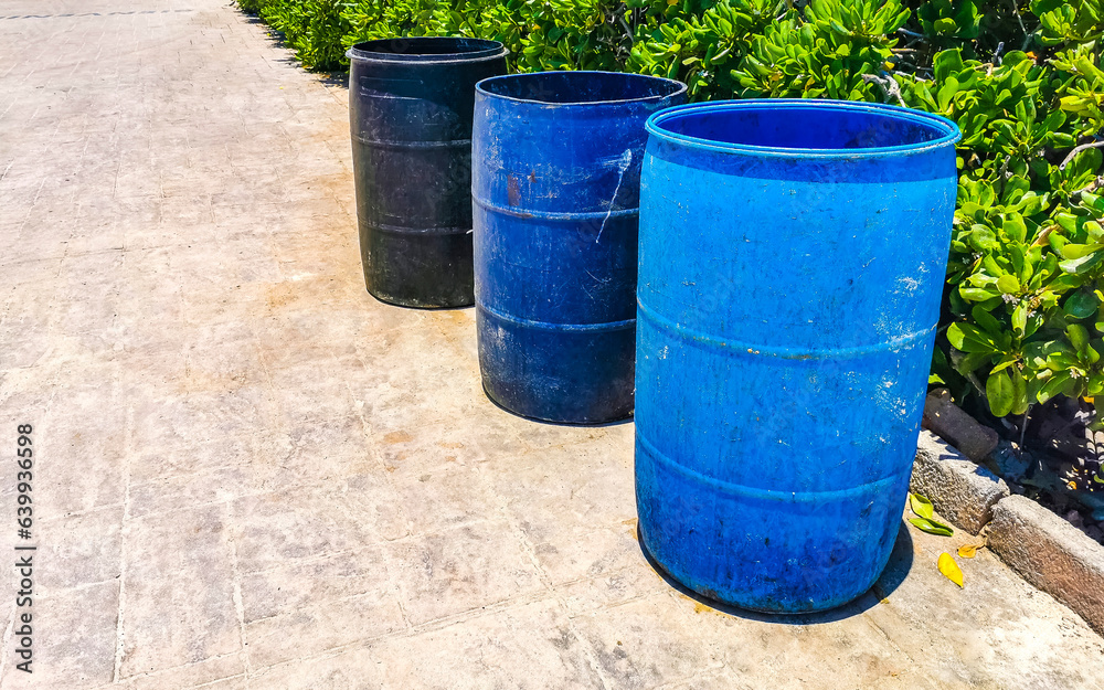 Blue trash garbage cans dirty street Playa del Carmen Mexico. Blue trash garbage cans dirty street Playa del Carmen Mexico.