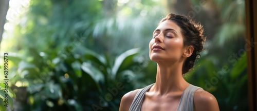 Young beautiful woman practicing mindful breathing or deep relaxation techniques, emphasizing the importance of breath awareness photo