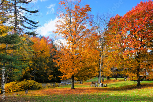 Fototapeta Naklejka Na Ścianę i Meble -  Vibrant fall colors with chairs and benches in the countryside of Vermont, USA