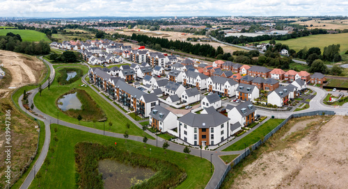 A modern housing development on the outskirts of a big city with new build houses