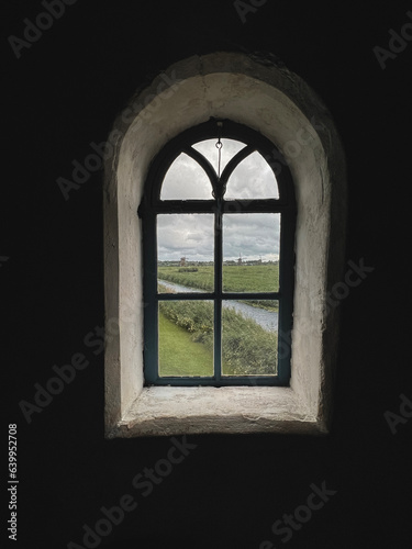 Vintage style window located inside a traditional Dutch windmill. Beautiful views looking out the window of the canals and windmills in Kinderdijk  Netherlands. A UNESCO World Heritage Site since 1997