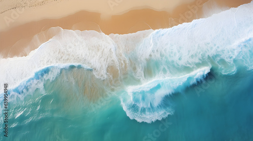 Captivating Aerial View of Sandy Beach Meeting Light Blue Waves with Sunlight Patterns.
