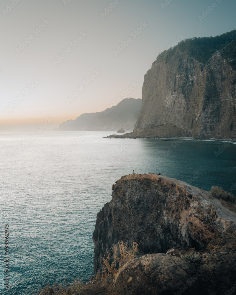 man watching the sunrise at Miradouro do Guindaste, Madeira