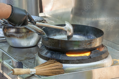 Cooking Asian food in a wok on the street. Fast food