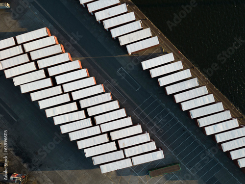 Aerial view lookig straight down at shipping containers in diagonal lines on the quayside at Tilbury Docks, Lower River Thames, UK