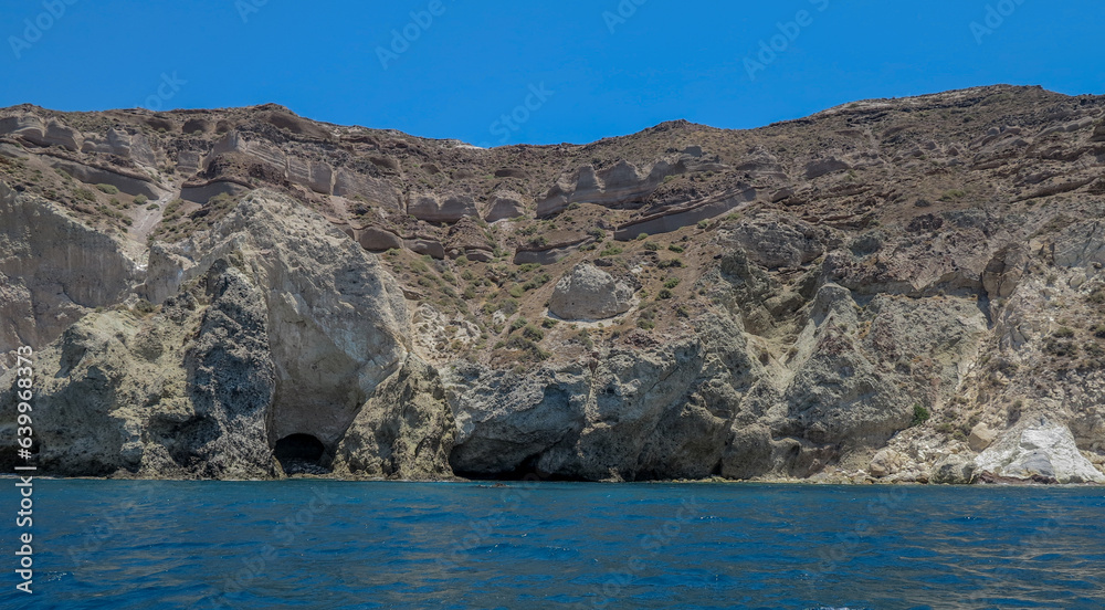view from the sea of the white beach of Santorini