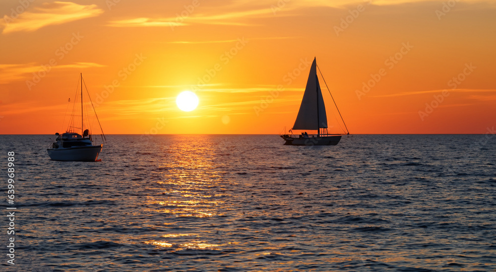 shadow of a sailboat on the sea with a beautiful sunset in high resolution