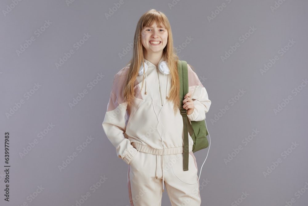 Portrait of smiling trendy girl in beige tracksuit Portrait of smiling trendy girl in beige tracksuit