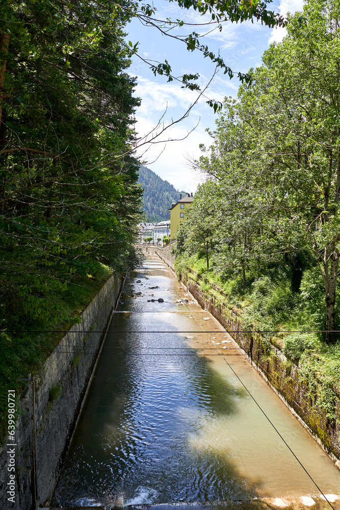 Obraz premium Aragon River as it passes through the old Canfranc station with the Pyrenees in the background.