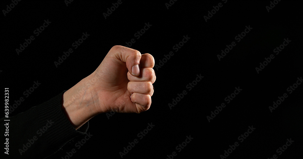 Hand of Woman making Sign against Black Background Hand of Woman making Sign against Black Background