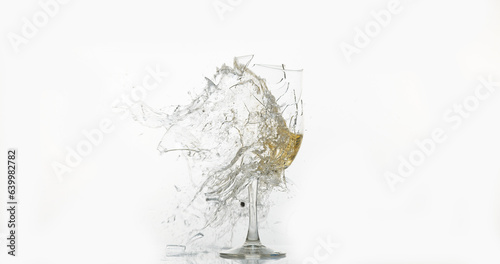 Glass of White Wine Breaking and Splashing against White Background
