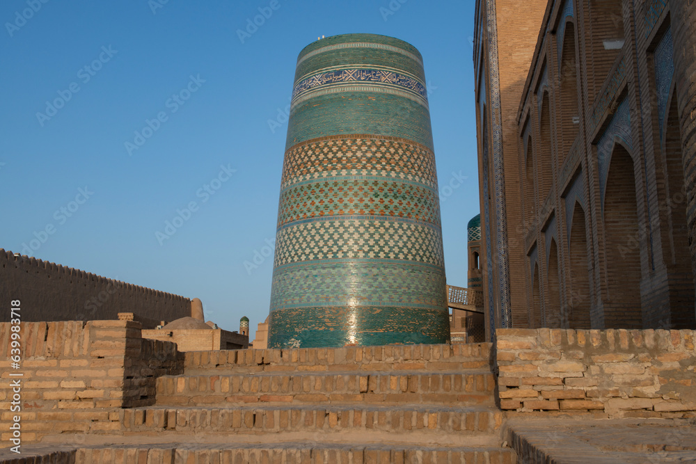 The Kalta Minor minaret on the background of a blue sky  in Ichan-Kala. Ichan-Kala is the inner city of the ancient Uzbek town of Khiva. the city is surrounded by powerful walls.