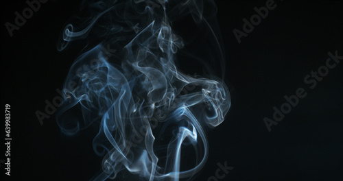 Smoke of Cigarette rising against Black Background