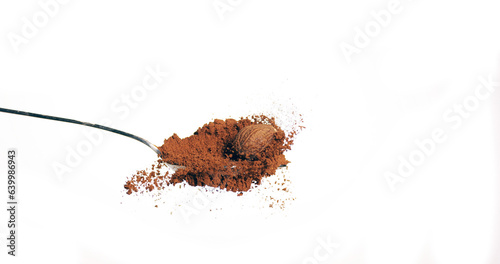 Nutmeg, myristica fragans, Nut falling on Nutmeg Powder against White Background photo