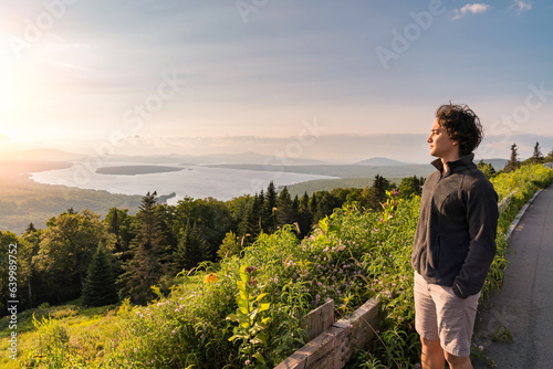 young man enjoying sunset at Height of land, Rangeley, Maine