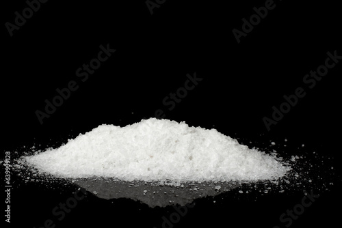 A pile of salt isolated on a black background.