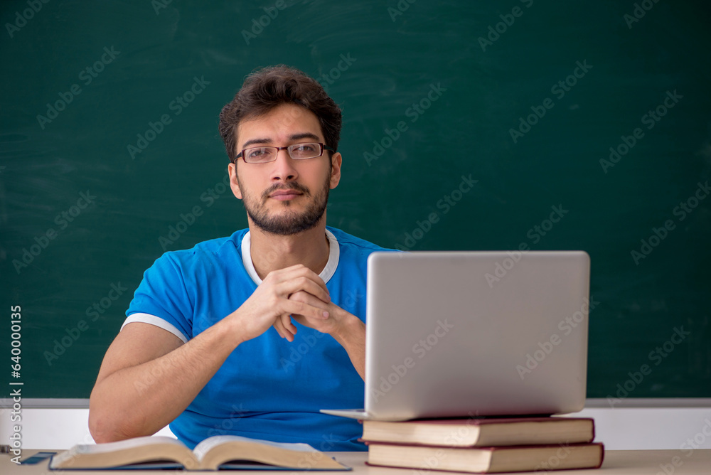 Young male student in telestudying concept Young male student in telestudying concept