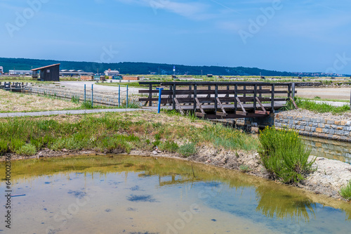 A view towards a bridge over feed channels at the salt pans at Secovlje, near to Piran, Slovenia in summertime