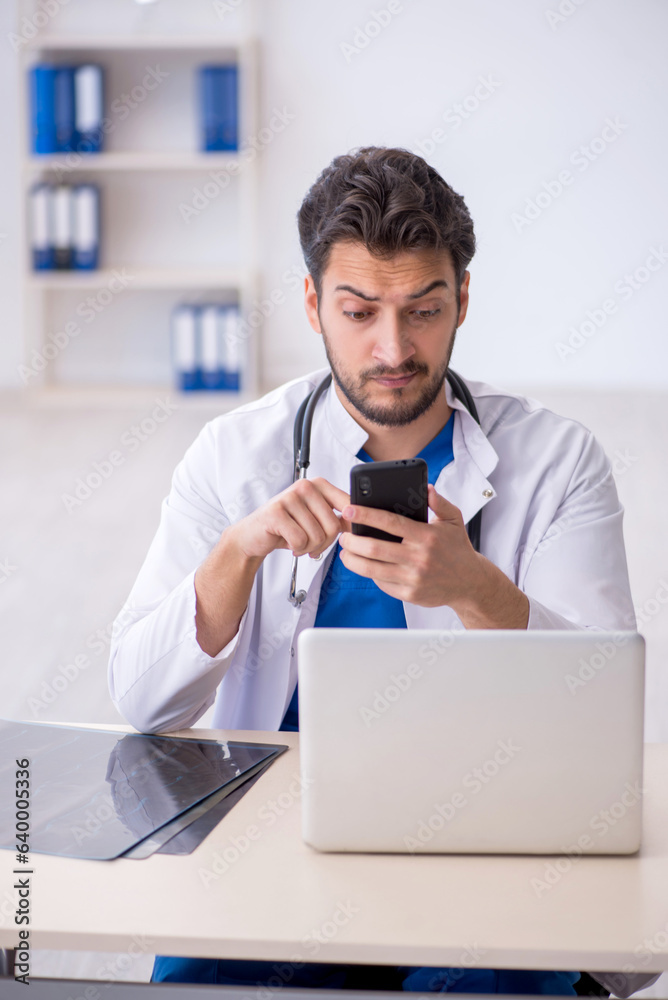 Fototapeta premium Young male doctor in telemedicine concept