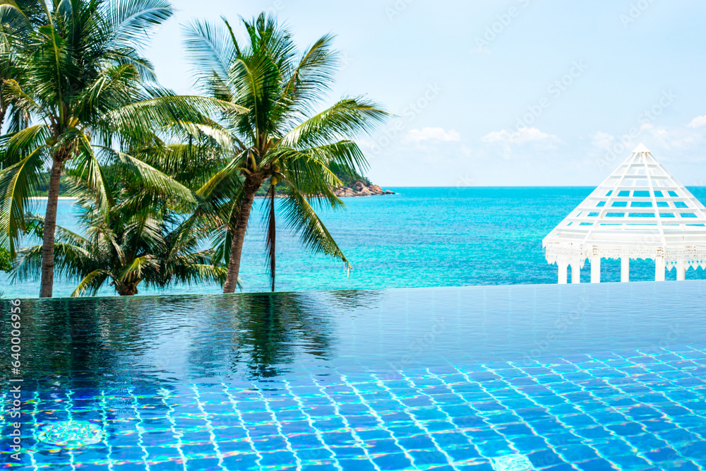 pool on the sea coast with palm trees and a white gazebo. Rest and relaxation at the seaside resort