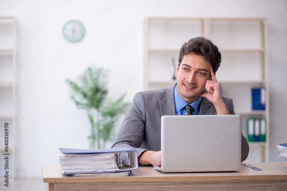 Young male employee working in the office Young male employee working in the office