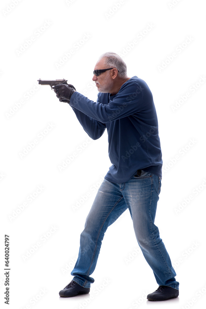 Old male burglar holding handgun isolated on white Old male burglar holding handgun isolated on white