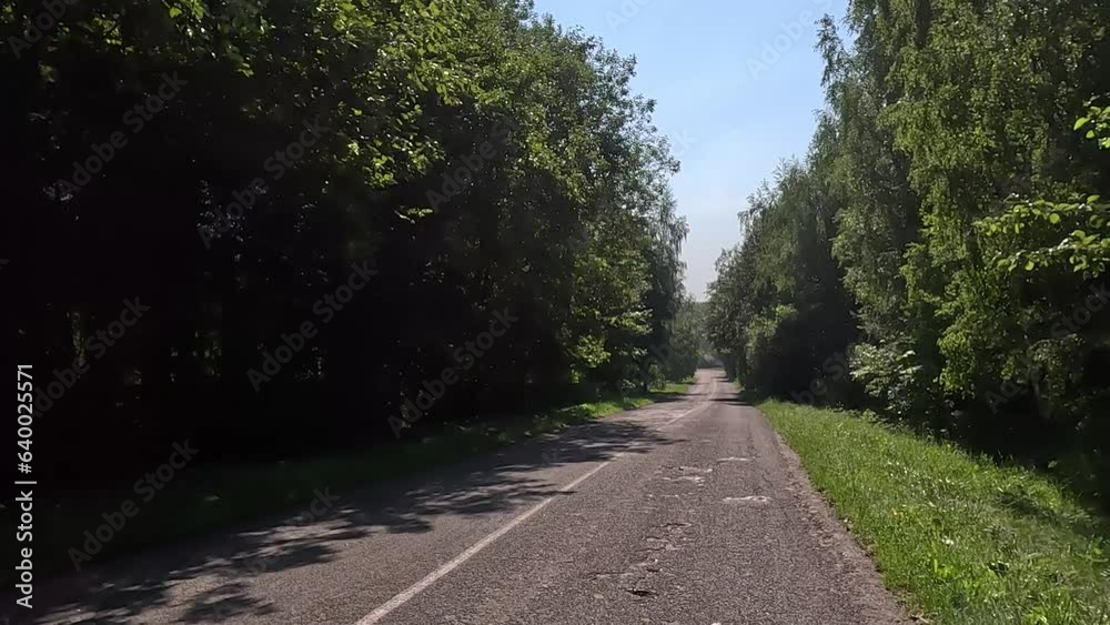 The car drives along the road on a summer day. Highways, roadside and road line markings. The car drives along the road on a summer day. Highways, roadside and road line markings.