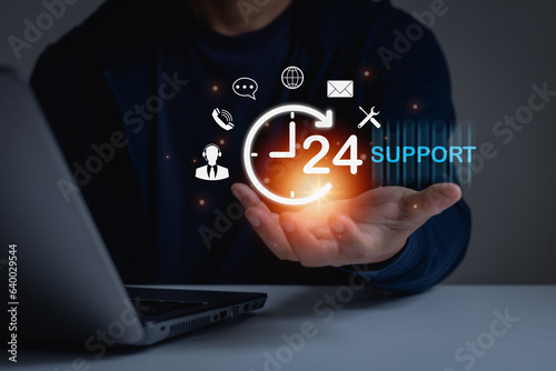 Call Center, Assistance customer services, Care and consulting clients 24hr. Businessman holding icon virtual 24 support services, worldwide nonstop and full-time available contact of service concept. photo