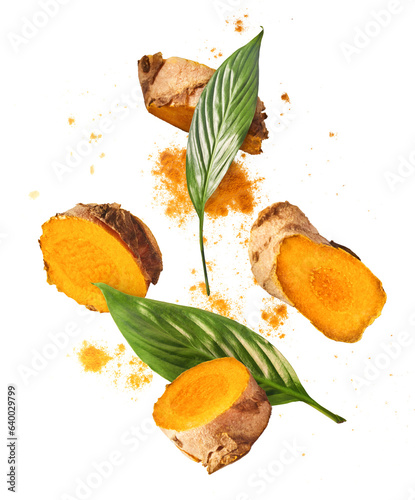 Fresh turmeric root falling in the air isolated photo