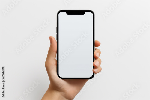Person holding smartphone mockup in their hand. Can be used to depict modern technology, communication, or social media usage.