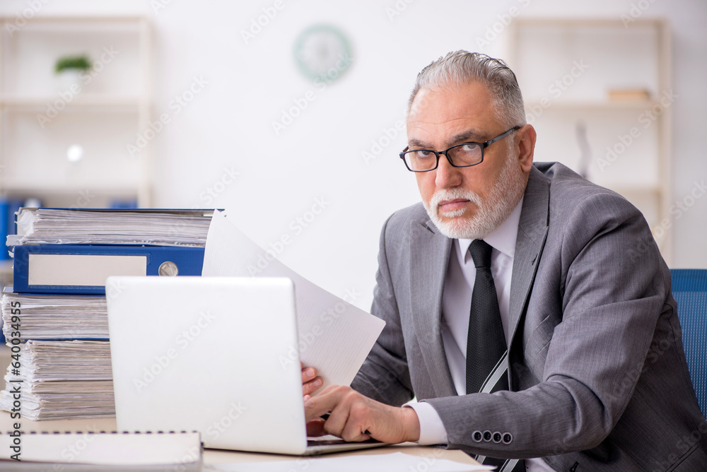 Old male employee and too much work in the office Old male employee and too much work in the office