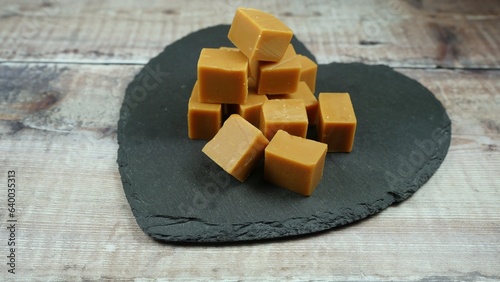 Clotted cream fudge, delicious sweet candy treat on a black slate heart