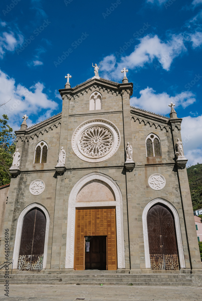 Facade of San Giovanni Battista church with gothic rose window in Riomaggiore, ITALY