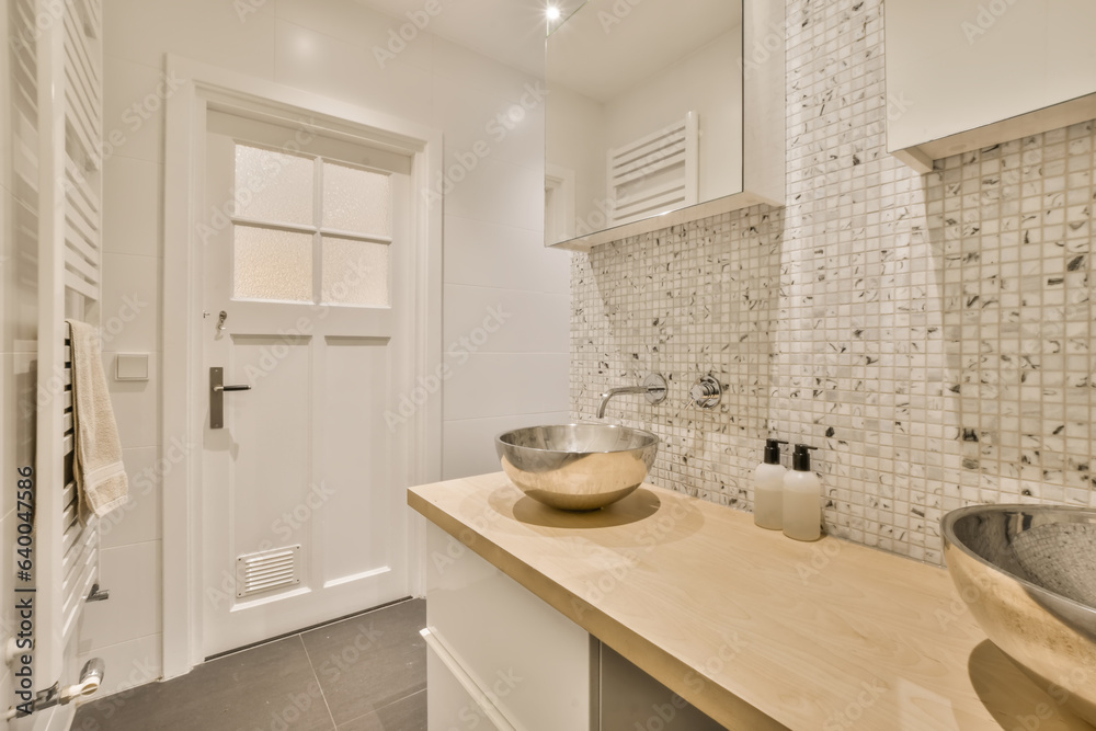a bathroom with two sinks on the counter and one sink in front of the mirror that has been used for storage a bathroom with two sinks on the counter and one sink in front of the mirror that has been used for storage