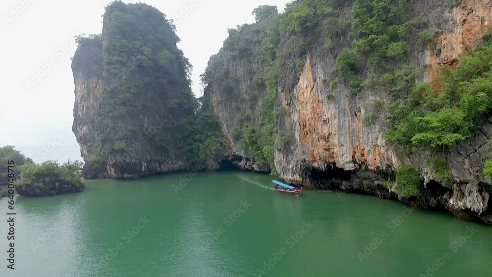 Aerial view amazing Panak island has a cave entrance into the canyon. .Visitors can take a canoe boat to see the big mangrove up in the valley..Panak island is the one landmark of Phang Nga Thailand Aerial view amazing Panak island has a cave entrance into the canyon. .Visitors can take a canoe boat to see the big mangrove up in the valley..Panak island is the one landmark of Phang Nga Thailand