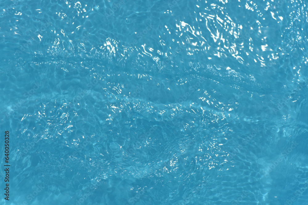 Blue water with ripples on the surface. Defocus blurred transparent blue colored clear calm water surface texture with splashes and bubbles. Water waves with shining pattern texture background. Blue water with ripples on the surface. Defocus blurred transparent blue colored clear calm water surface texture with splashes and bubbles. Water waves with shining pattern texture background.
