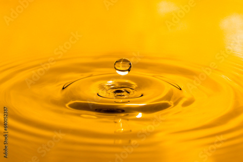 yellow drop oil , Liquid gold oil drop ripple background.
