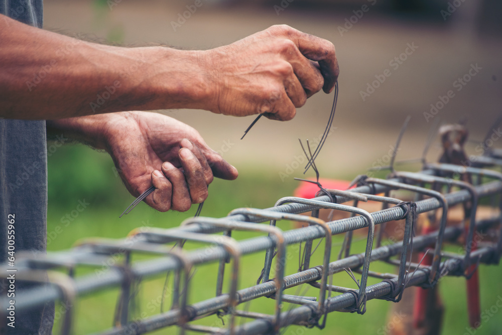 Construction Men hands bending cutting steel wire fences bar