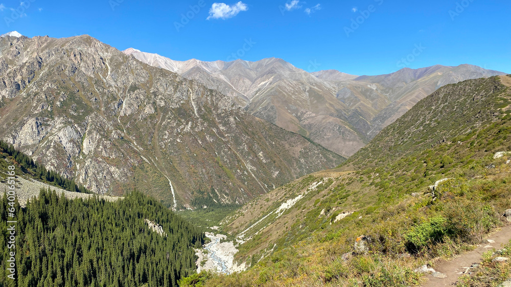 Beautiful mountain landscape. Amazing panorama of green wooded hills, slopes, rocks, ridges and mountains. Ala Archa National Park in Kyrgyzstan