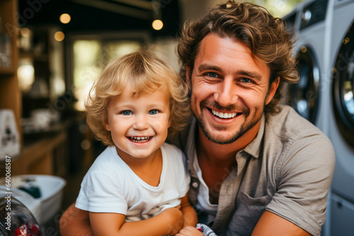 Close up of a father holding his child before unloading the washing machine