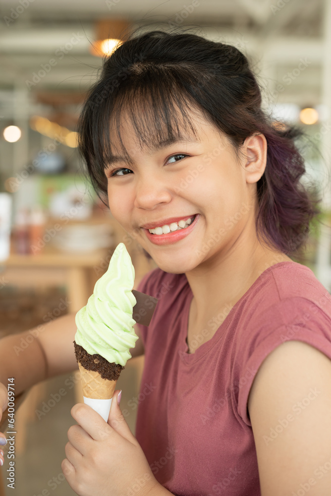Happy teen girl 11-15 year old. Beautiful young asian woman eating ice cream, Cheerful asian female portrait during summertime vacation, Leisure, people and lifestyle concepts, cafe. Happy teen girl 11-15 year old. Beautiful young asian woman eating ice cream, Cheerful asian female portrait during summertime vacation, Leisure, people and lifestyle concepts, cafe.