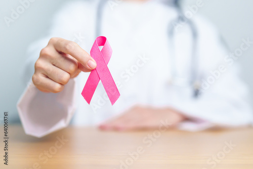 Pink October Breast Cancer Awareness month, woman doctor with pink Ribbon in hospital for support people life and illness. National cancer survivors month, Mother and World cancer day concept