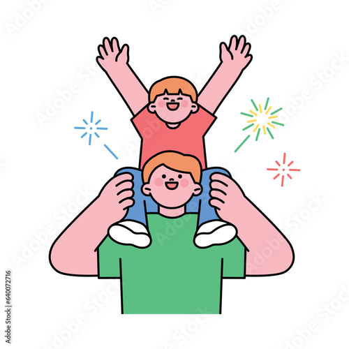 Festival. A father holds his child on his shoulders and enjoys a fireworks display.