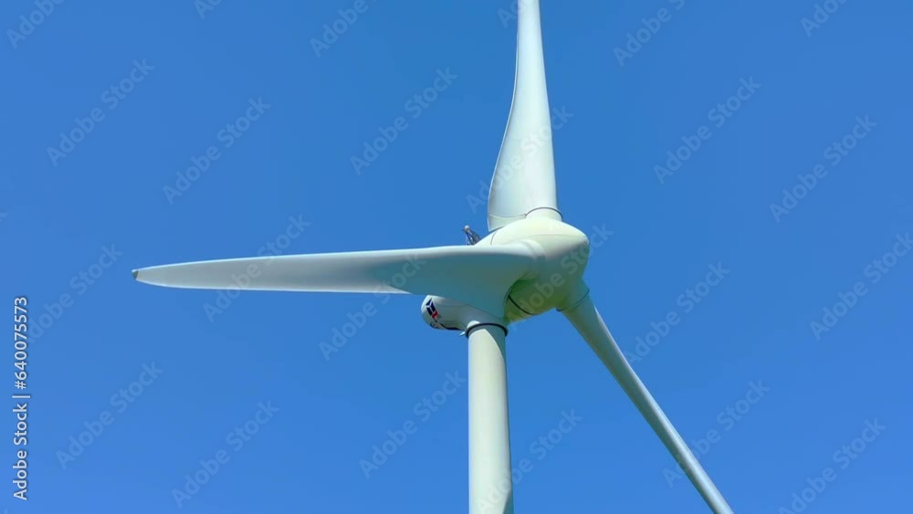 Close-up view of wind turbines against blue skies at Ystad, Scania, Sweden, Scandinavia, Europe Close-up view of wind turbines against blue skies at Ystad, Scania, Sweden, Scandinavia, Europe