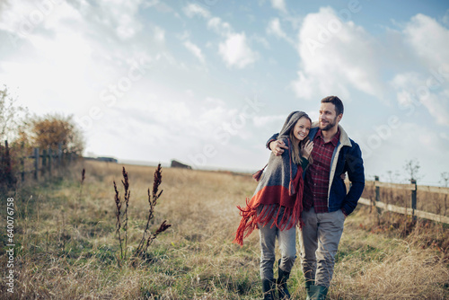 Young caucasian couple walking together in the countryside