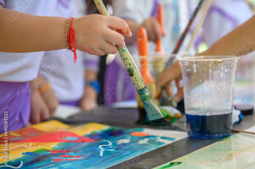 Children and friends paint with their own creativity in colorful colors in kindergarten class in school. Children paint water or crayons on drawing paper.